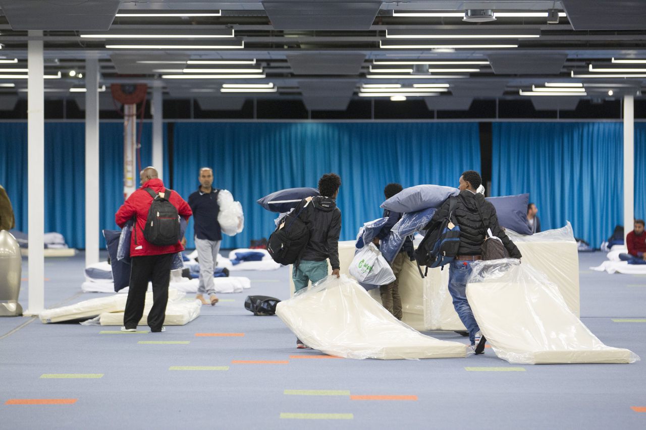 Vluchtelingen in het Beatrixgebouw in de Jaarbeurs., waar sinds gisteren 500 vluchtelingen tijdelijk kunnen worden opgevangen.