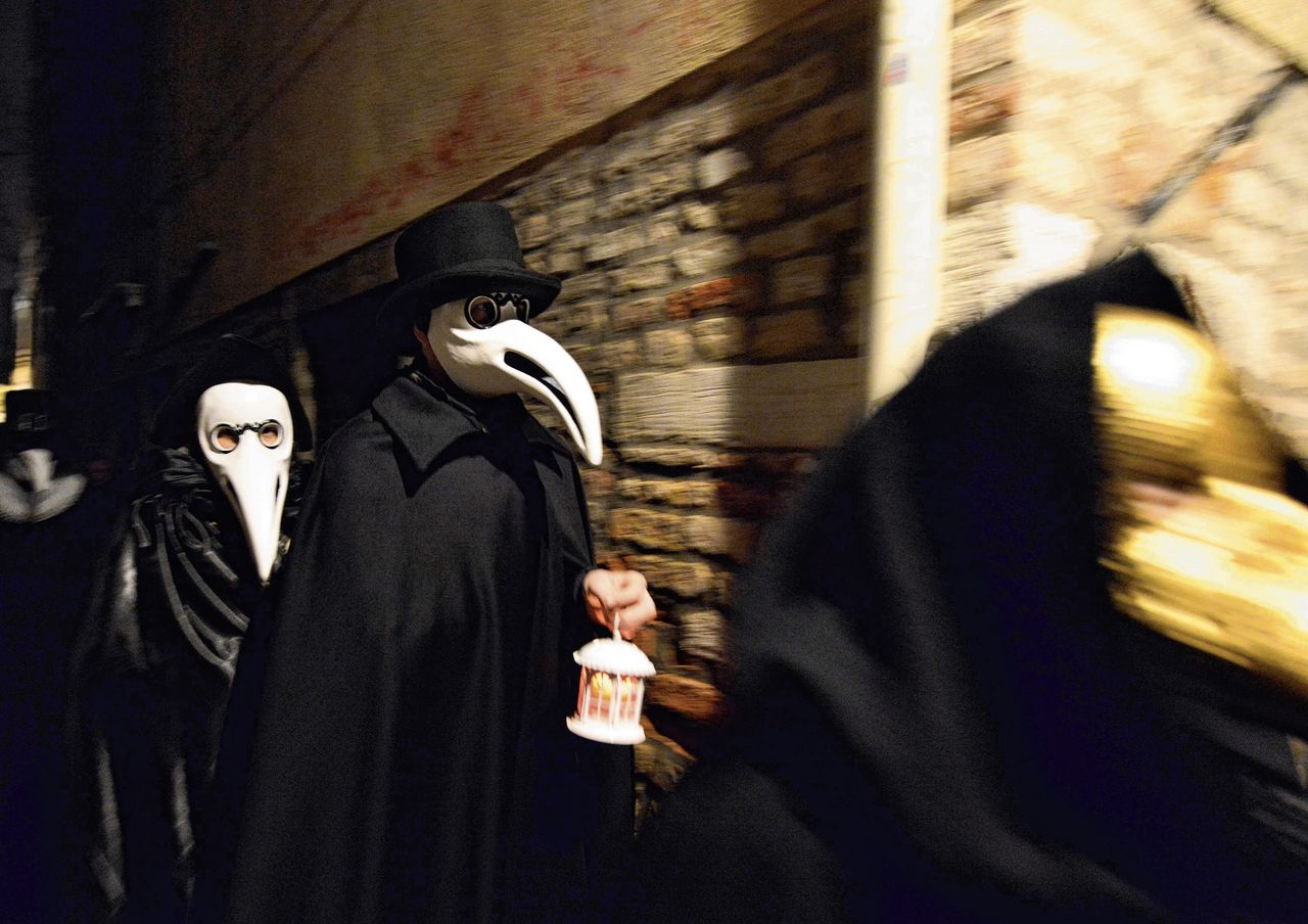 Carnavalsvierders tijdens de ‘pestprocessie’ in Venetië met maskers die in de Middeleeuwen door dokters werden gedragen tijdens een epidemie. In de ‘neus’ zaten kruiden die bescherming heetten te bieden.