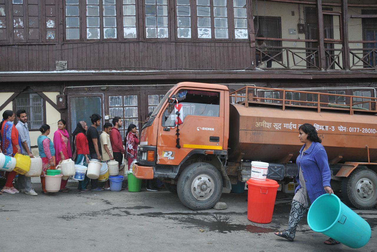 Inwoners van India staan in de rij om water te halen in Shimla