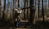 The 79-year-old Oleksandra Vasejko in the forest where Poles are buried that died in 'The massacre of Wolynia'. 