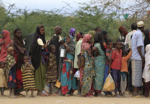 Somali refugees wait to board a bus to another camp, at Ifo, outside Dadaab, Kenya, Thursday, July 14, 2011. East Africa's drought is battering Somali children, hundreds of whom have been left for dead on the long, dry journey to the world's largest refugee complex in Dadaab, northern Kenya. UNICEF on Thursday called the drought and refugee crisis "the most severe humanitarian emergency in the world."(AP Photo/Rebecca Blackwell)