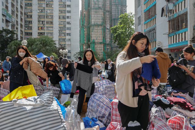Volunteers sort donated clothing for affected residents at a volunteer camp at the Wang Fuk Court housing complex following a deadly fire, in Tai Po, Hong Kong, China, November 28, 2025. REUTERS/Tyrone Siu