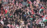 Jordanians wave the national flag during a protest against Trump's comments about Gaza. Photo Jordan Pix/Getty Images 