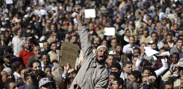 People demonstrate in Cairo, Egypt, Monday, Jan. 31, 2011. A coalition of opposition groups called for a million people to take to Cairo's streets Tuesday to ratchet up pressure for President Hosni Mubarak to leave. (AP Photo/Ben Curtis)
