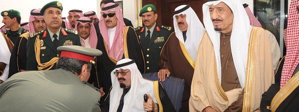 Saudi Arabia's King Abdullah (C, seated) is greeted by a Saudi officer on his arrival at Riyadh airport in this February 23, 2011 file photo. When Saudi King Abdullah arrived home last week, he came bearing gifts: handouts worth $37 billion, apparently intended to placate Saudis of modest means and insulate the world's biggest oil exporter from the wave of protest sweeping the Arab world. But some of the biggest handouts over the past two decades have gone to his own extended family, according to unpublished American diplomatic cables dating back to 1996. To match Special Report WIKI/SAUDI-MONEY REUTERS/Saudi Press Agency/Handout/Files
