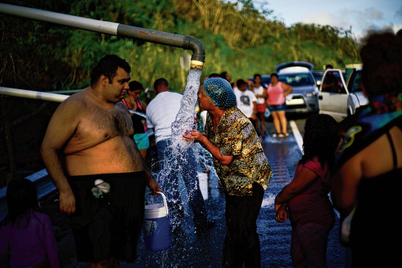 Links: Inwoners wassen zich zaterdag met rivierwater uit een pijpleiding in de bergen van Utuado in Puerto Rico. Rechts: een verwoest huis in de noordelijke gemeente Toa Baja, op een foto van donderdag.