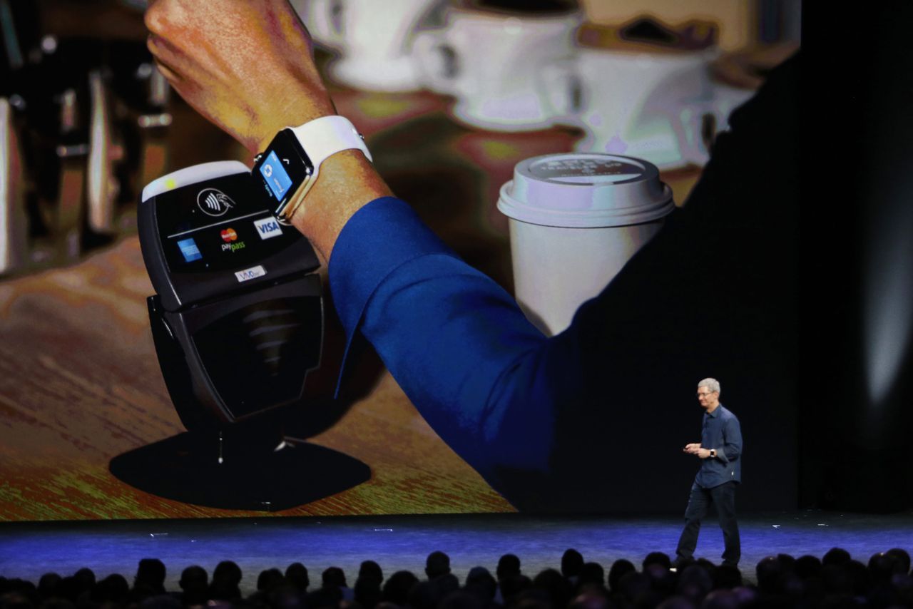 epa04392930 Apple CEO Tim Cook demonstrates the Apple Pay system using an Apple Watch during Apple's launch event at the Flint Center for the Performing Arts in Cupertino, California, USA, 09 September 2014. The Flint Center for the Performing Arts was the site where Steve Jobs launched the first Apple Macintosh computer in 1984. EPA/MONICA DAVEY