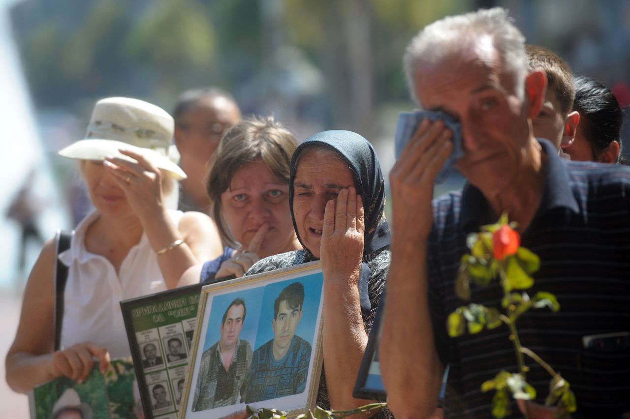 Serbs cry as they hold pictures of their missing relatives during the International Day of the Disappeared in Belgrade on August 30, 2011. Some 14,000 people are unaccounted for after the wars in Croatia, Bosnia Hercegovina and Kosovo, which tore apart the former Yugoslavia in the 1990s. Families throughout the western Balkans still hope to find out what has happened to their missing loved ones, if only to bury and grieve for them properly. AFP PHOTO / ALEXA STANKOVIC