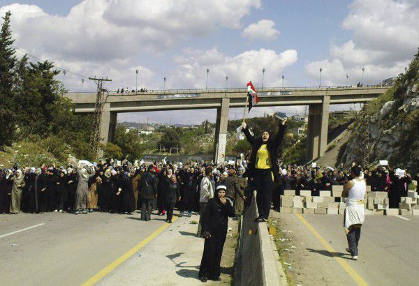 ** CORRECTS DATE ** Women hold a n anti-government demonstration in Banias, Syria, Wednesday, April 13, 2011. Thousands of Syrian women and children holding white flags and olive branches blocked a main coastal highway Wednesday, demanding authorities release people detained during a crackdown on opponents of the regime, witnesses said. The crowd unusual because it was dominated by women and young children demanded release of hundreds of men who have been rounded up in the northeastern villages of Bayda and Beit Jnad and surrounding areas in recent days. (AP Photo)