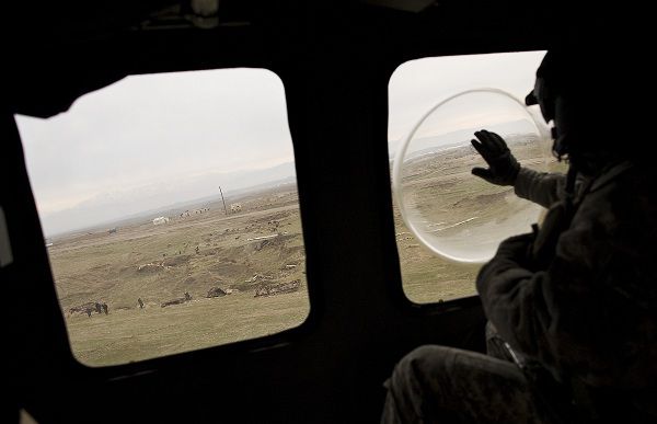A soldier with the U.S. Army's Task Force Mustang "Dust Off" Company based out of Fort Hood, Texas, waves to Afghan children on the ground during a mission in his Blackhawk medevac helicopter in Kunduz, north of Kabul, Afghanistan, Monday, Feb. 21, 2011. (AP Photo/Anja Niedringhaus)