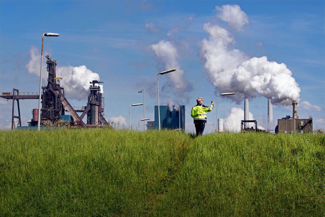 Een inspecteur van de omgevingsdienst aan de rand van het terrein van Tata Steel IJmuiden.