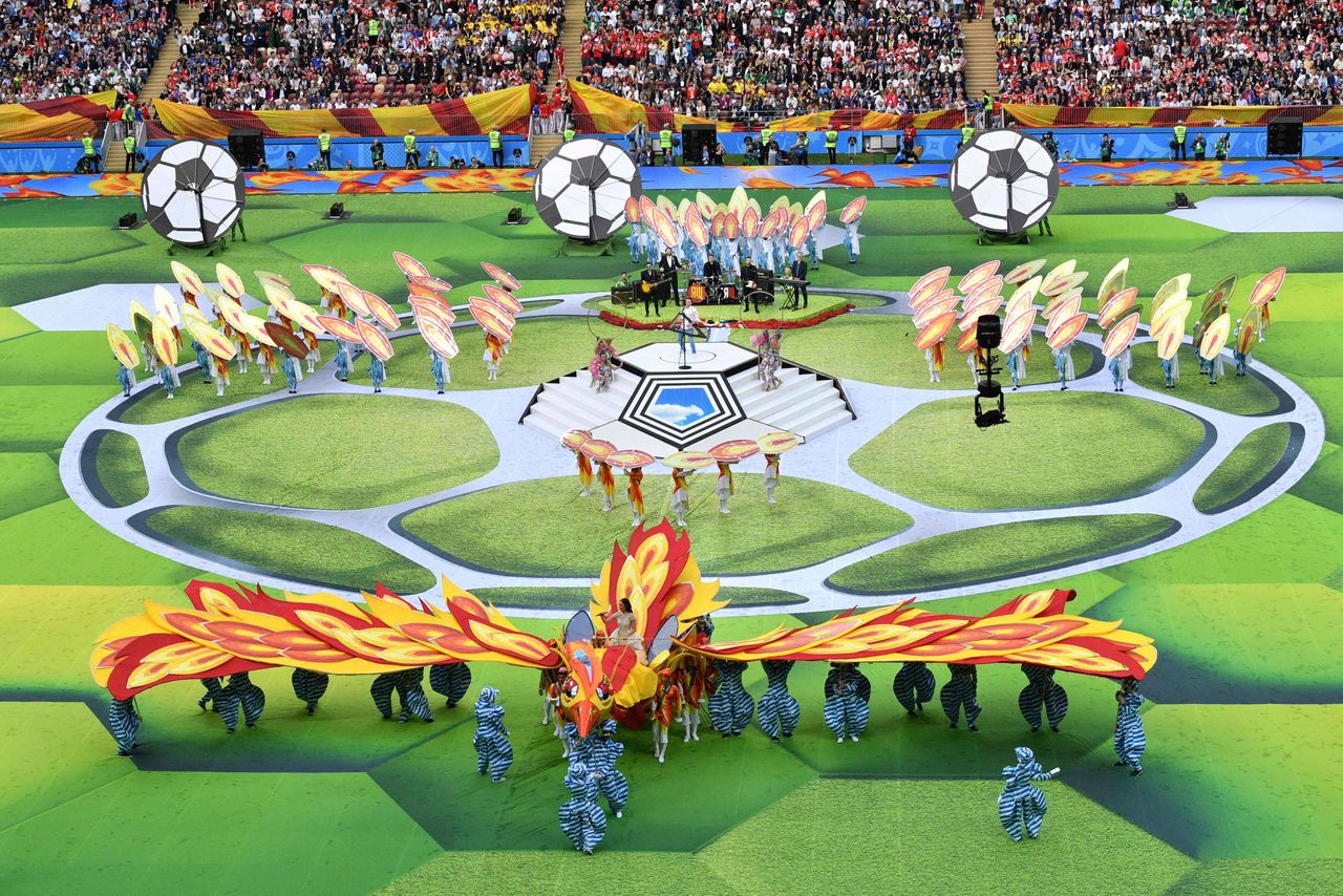 Zangeres Aida Garifoellina zingt, gezeten op een vuurvogel, een duet met Robbie Williams tijdens de openingsceremonie van het WK.