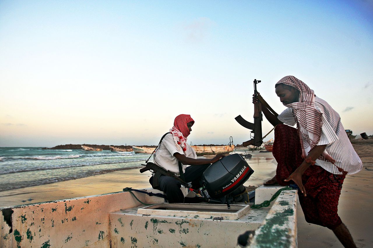 (FILES) Photo taken on January 4, 2010 shows armed Somali pirates carrying out preparations to a skiff in Hobyo, northeastern Somalia, ahead of new attacks on ships sailing in the Gulf of Aden. Pirates holding ships just off the Somali town of Harardhere moved them on May 3, 2010 after Islamist militants seized the town, residents and pirates said. "The Islamists have not interfered with us yet but some ships near Harardhere were moved in order to avoid any attempt to interfere," Abdi Yare, a pirate in the nearby coastal town of Hobyo, another pirate hub, told AFP. AFP PHOTO FILES / MOHAMED DAHIR