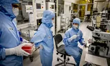 Werknemers aan het werk in de Else Kooi cleanroom van laboratoria op de TU Delft. Hier worden innovaties voor de chipindustrie onderzocht. 
