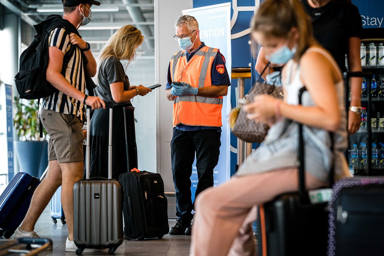 Reizigers worden bij terugkeer op Eindhoven Airport gecontroleerd op hun coronabewijs.