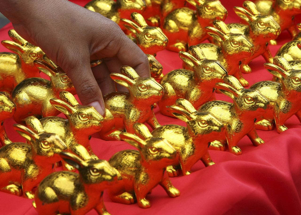 A vendor arranges her display of gold-plated rabbit as she peddles along a street at Manila's Chinatown district of Binondo on Wednesday Feb. 2, 2011, the eve of the Chinese Lunar New Year celebration in the Philippines. This year is the Year of the Rabbit in the Chinese calendar. (AP Photo/Bullit Marquez)