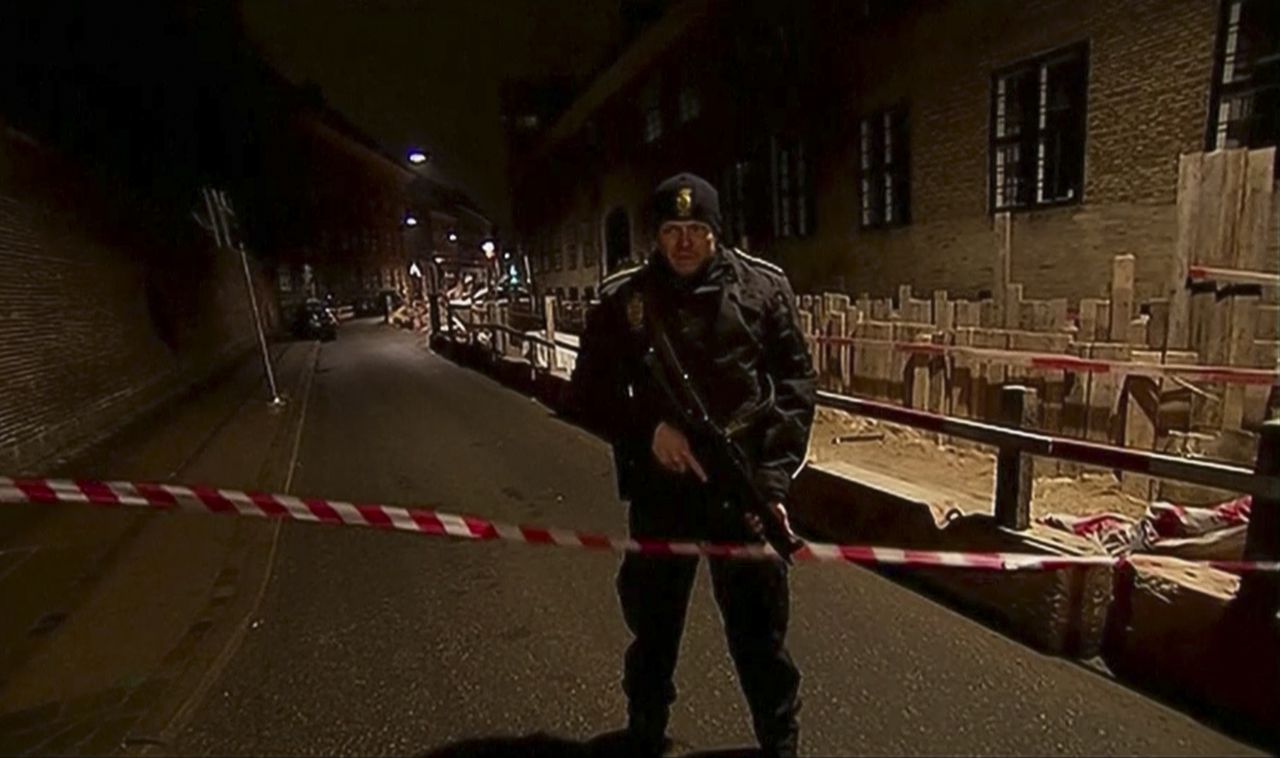 Een gewapende agent bij een afzetting nabij de synagoge in het centrum van Kopenhagen waar rond middernacht tijdens een schietpartij een jonge Joodse man werd gedood en twee agenten werden verwond.