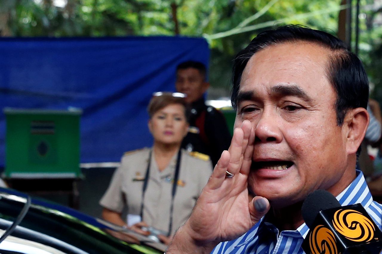 De Thaise juntaleider Prayuth Chan-ocha spreekt de media toe bij een stembureau in Bangkok tijdens het referendum over de nieuwe grondwet.