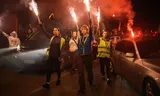 Students from Novi Pazar hold flares along a road on their 420-km journey to Novi Sad during a protest march over the fatal November 2024 Novi Sad railway station canopy collapse, which killed 16 people, triggering nationwide accusations of widespread corruption and negligence in Kosjeric, Serbia, October 23, 2025.    
