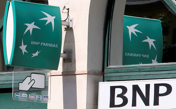 Caption: Signs of BNP Paribas Bank outside a branch in Nice, southeastern France, Wednesday, Sept. 14, 2011. Moody's on Wednesday downgraded the credit ratings of French banks Societe Generale and Credit Agricole following a period of huge volatility in the markets as investors fretted about their potential exposure to the debts of Greece. Some sort of move by Moody's had been widely expected this week.The agency had put them and rival BNP Paribas on review for downgrade in mid-June. (AP Photo/Lionel Cironneau )