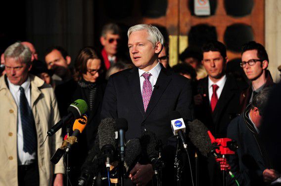 WikiLeaks founder Julian Assange (L) speaks to the media after leaving the High Court in London on December 5, 2011 where he attended a ruling in his long-running fight against extradition to Sweden. Assange was on December 5 granted permission to apply to England's highest court in a final attempt to block his extradition to Sweden over rape allegations. AFP PHOTO / BEN STANSALL