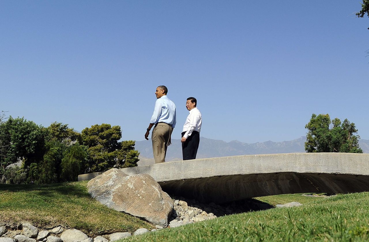 US President Barack Obama (L) and Chinese President Xi Jinping chat as they take a walk at the Annenberg Retreat at Sunnylands in Rancho Mirage, California, on June 8, 2013. Obama and Xi wrap up their debut summit Saturday, grasping for a personal understanding that could ease often prickly US-China relations. Skipping the usual summit pageantry, Obama and Xi went without neckties, in a departure from the stifling formality that marked Obama's halting interactions with China's ex-president Hu Jintao. AFP PHOTO/Jewel Samad